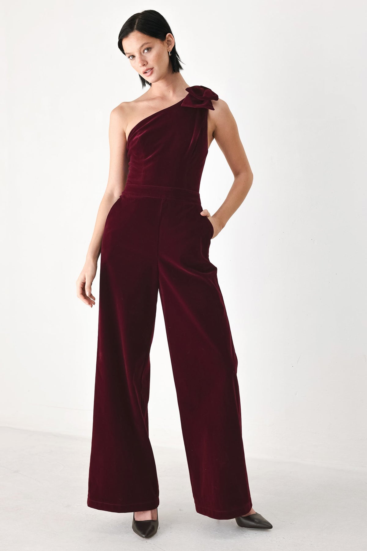 BERRY AFTER DARK VELVET BOW ONE-SHOULDER JUMPSUIT