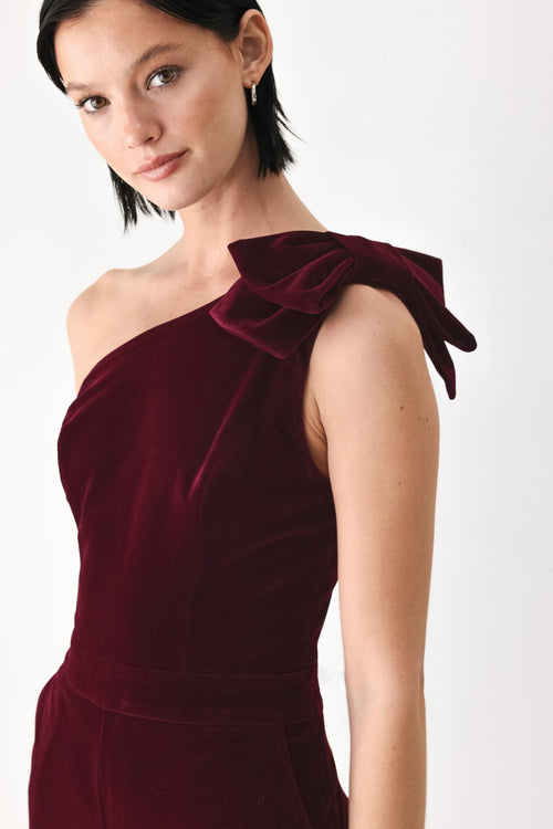 BERRY AFTER DARK VELVET BOW ONE-SHOULDER JUMPSUIT